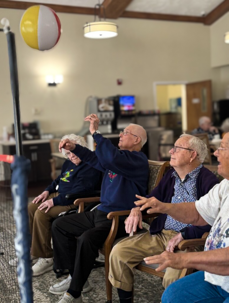 Residents at Cedar Trails Senior Living participate in a spirited game of chair beachball volleyball.