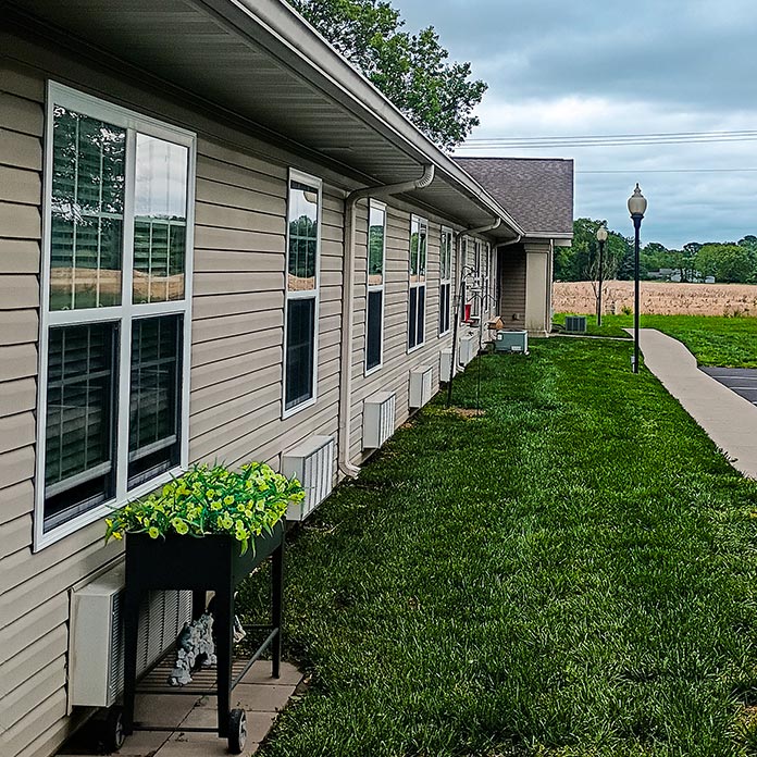 The exterior of Cedar Trails Senior Living showcasing landscaped grounds.