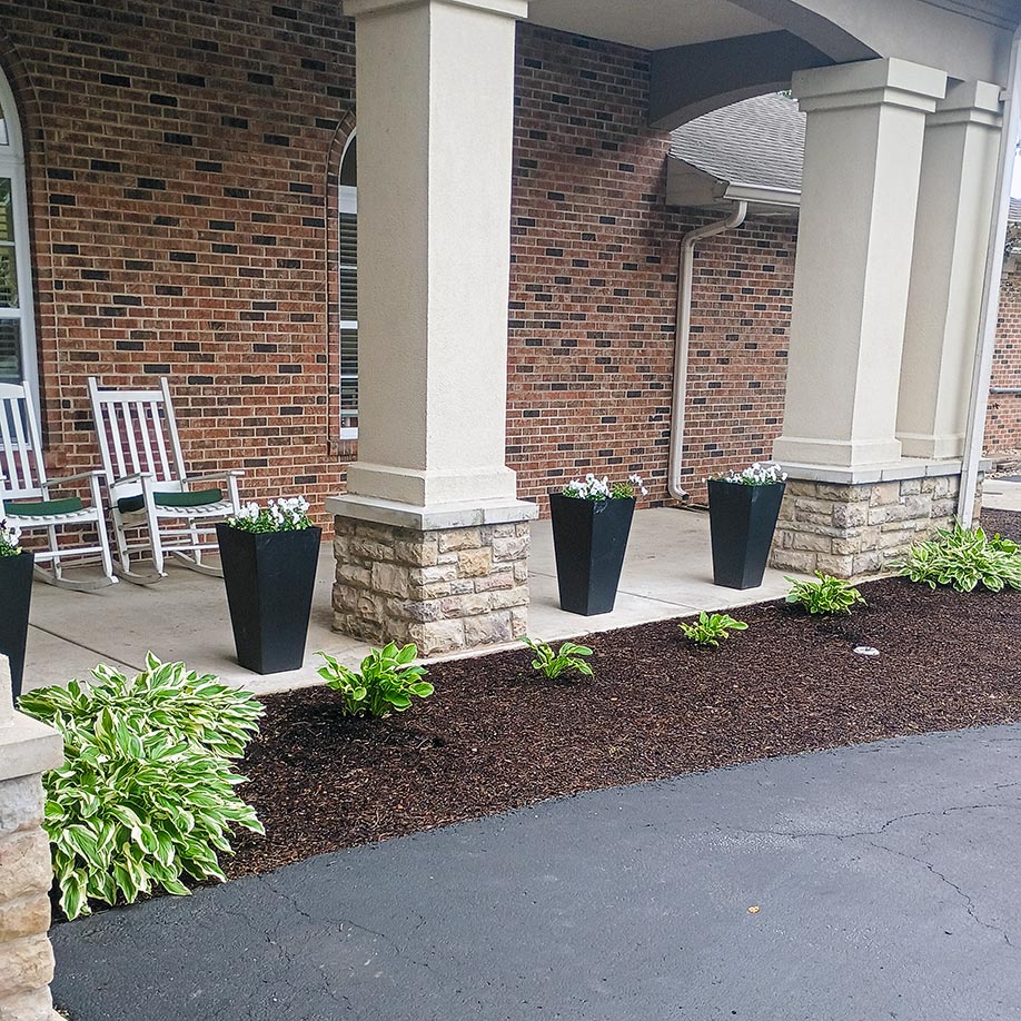 A landscaped area with planters and foliage at Cedar Trails.